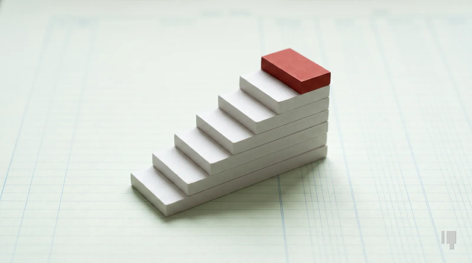 A staircase of seven card blocks with a red top step