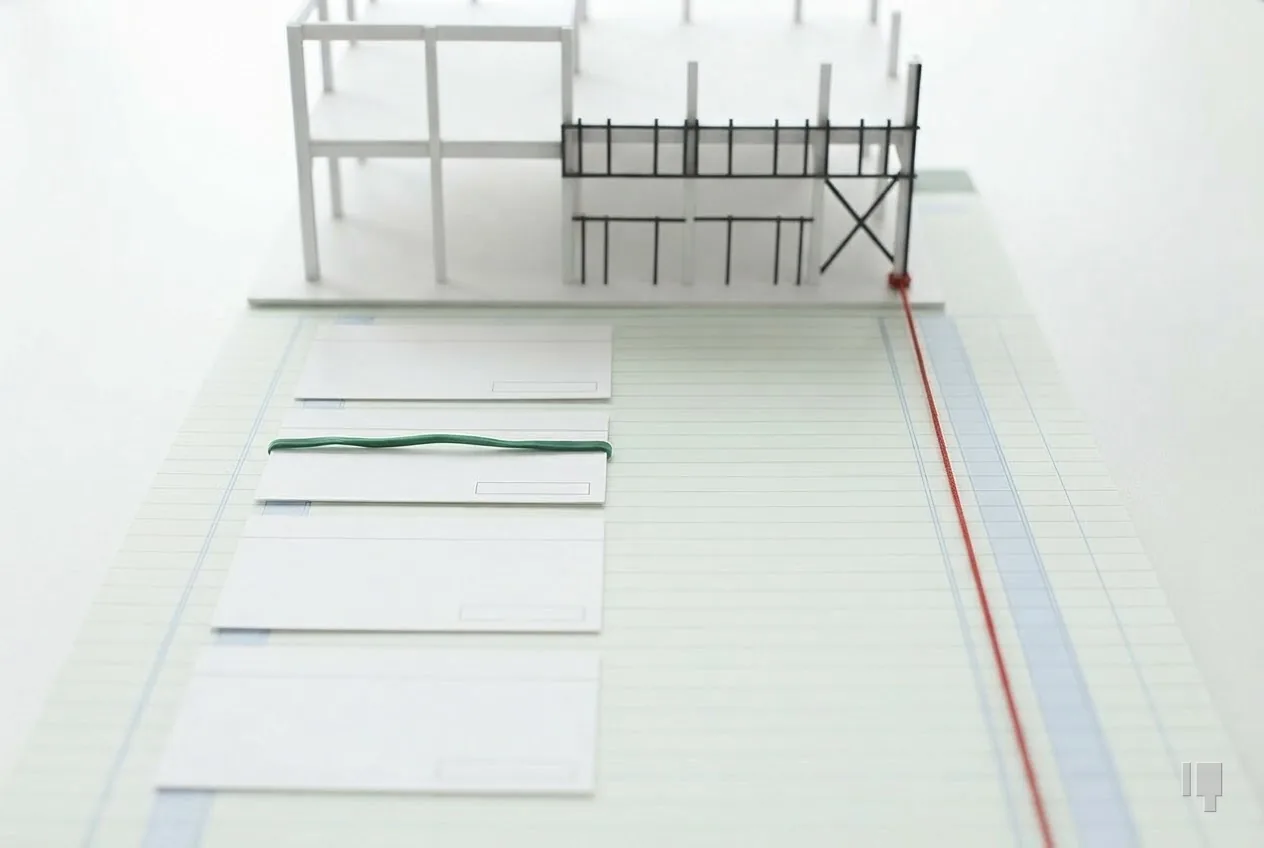 Index cards stepping down and a red string running back up to a card building model